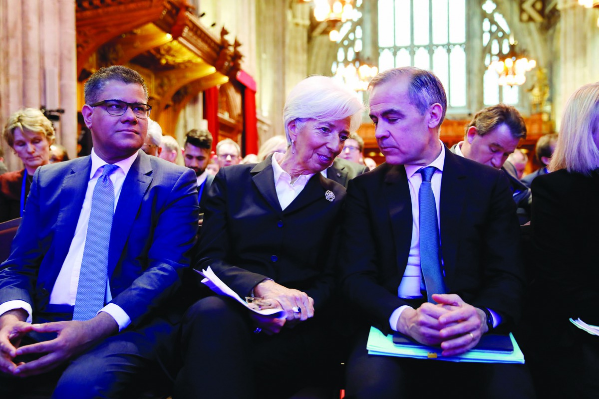 Mark Carney, Governor of the Bank of England, talks with President of the European Central Bank Christine Lagarde seated next to Britain's Business Secretary and Minister for COP26 Alok Sharma during an event to launch the private finance agenda for the 2