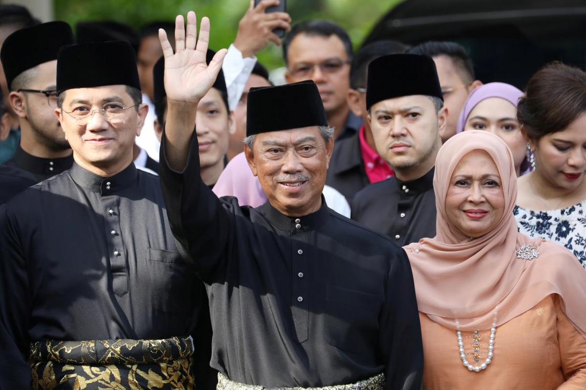 Malaysia's Prime Minister Designate and former interior minister Muhyiddin Yassin waves to reporters before his inauguration as the 8th prime minister, outside his residence in Kuala Lumpur, Malaysia, March 1, 2020. REUTERS/Lim Huey Teng