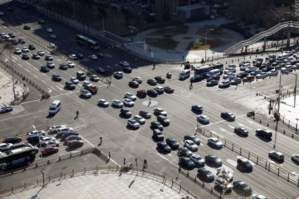 Vehicles are seen at an intersection to Changan Avenue, Beijing's main thoroughfare, as the country is hit by an outbreak of the new coronavirus, in China March 3, 2020. REUTERS/Carlos Garcia Rawlins