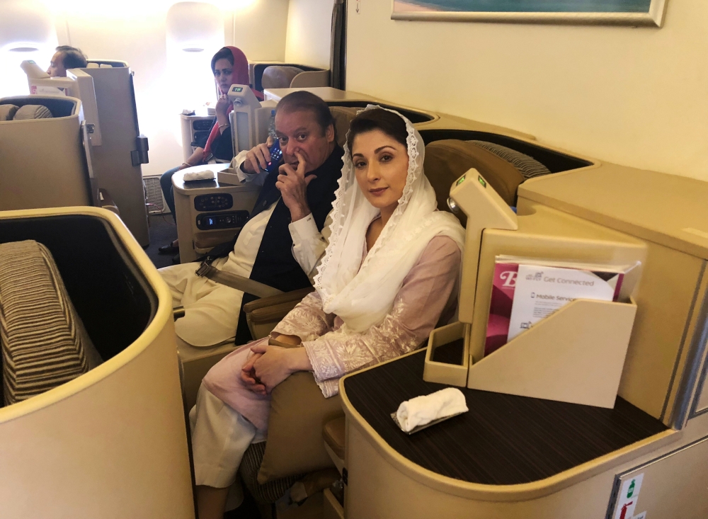 FILE PHOTO: Nawaz Sharif and his daughter Maryam sit on a Lahore-bound flight due for departure at Abu Dhabi International Airport, July 13, 2018. Reuters / Drazen Gorgic
