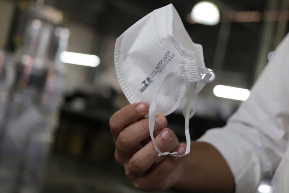 A man holds a PFF2 respirator mask at Delta Plus plant in Socorro, Sao Paulo state, Brazil March 3, 2020.  Reuters/Rahel Patrasso