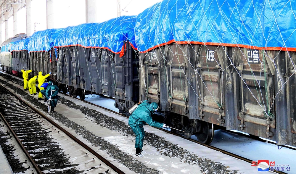 Workers disinfecting freight trains to prevent the spread of the COVID-19 coronavirus in Sinuiju, North Pyongan Province, North Korea in a picture released  on March 4, 2020. AFP / KCNA via KNS 
