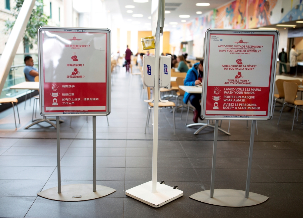 Signs in Chinese, French and English are posted for visitors and staff at the Jewish General Hospital in Montreal, Quebec, Canada March 2, 2020. Reuters/Christinne Muschi