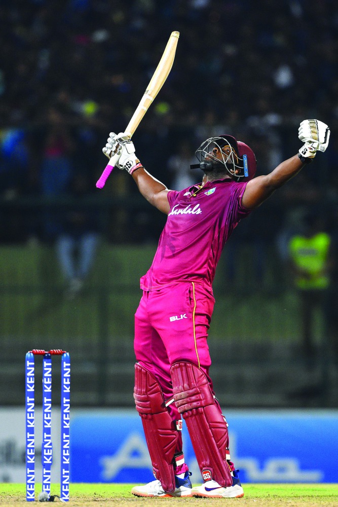 West Indies' batsman Andre Russell celebrates after scoring the winning run to defeat Sri Lanka by seven wickets during the second Twenty20 international cricket match of a two-match series between Sri Lanka and West Indies at the Pallekele International 
