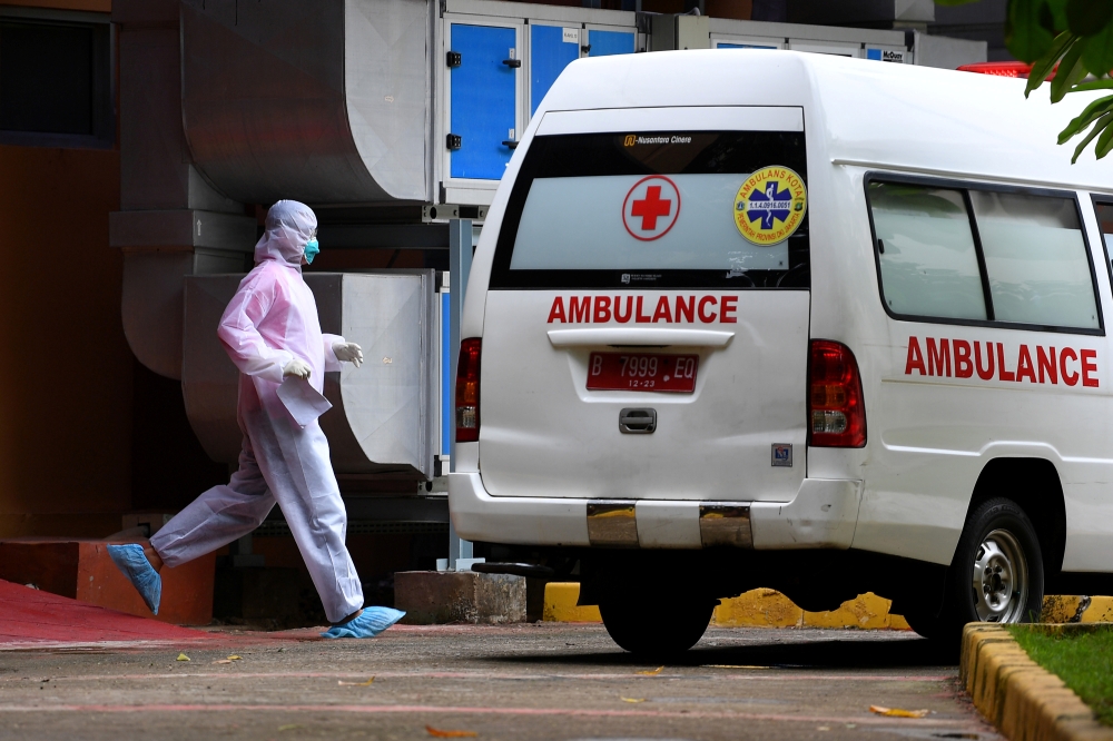  A medical staff member wearing a protective suit walks towards the ambulance near an isolation room at Sulianti Saroso hospital, after indonesia confirmed its first cases of coronavirus disease (COVID-19), in Jakarta, indonesia, March 5, 2020 in this pho