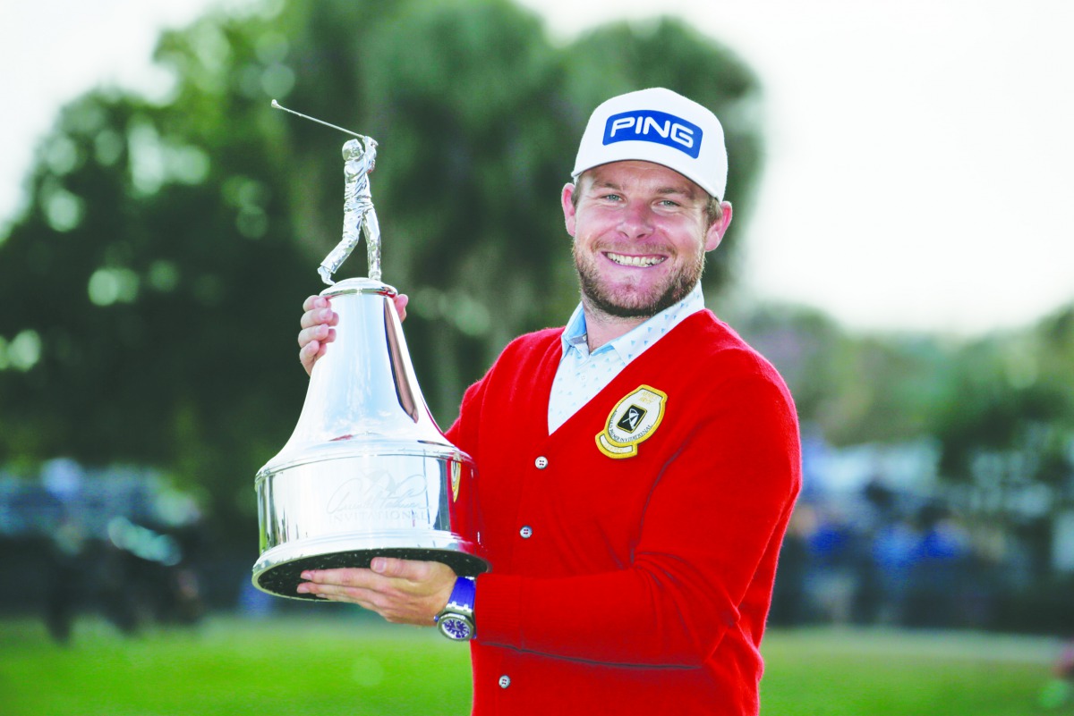 Tyrrell Hatton wears a red alpaca cardigan sweater given to the winner as he holds the champions trophy after winning the Arnold Palmer Invitational golf tournament at Bay Hill Club & Lodge Mar 8, 2020; Orlando, Florida. Credit: Reinhold Matay-USA TODAY S