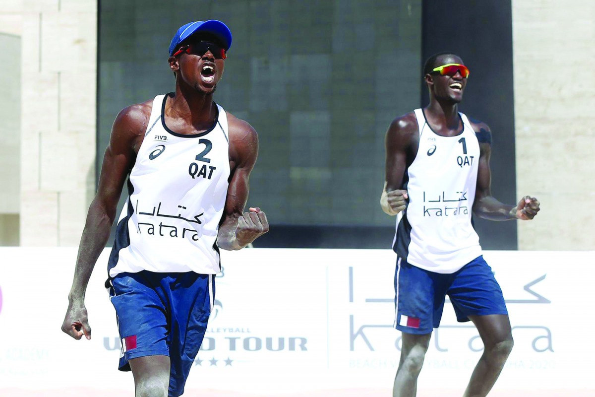 Qatar's Ahmed Tijan (left) and  Cherif Younousse celebrate a point yesterday.