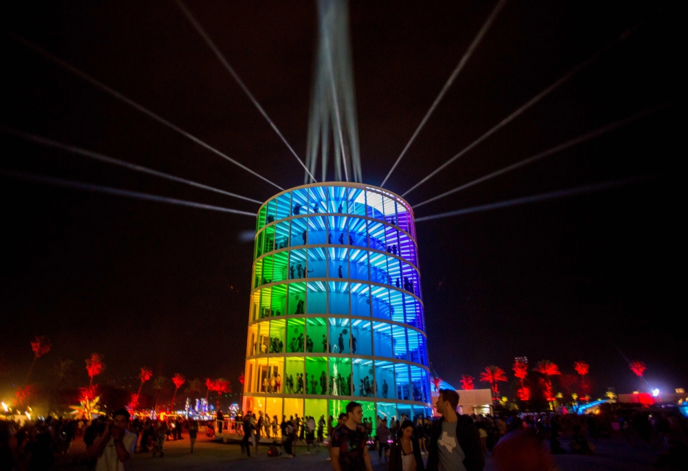 In this file photo taken on April 15, 2018 people enter and exit the Spectra installation by Newsubstance Sunday at the Coachella Music and Arts Festival in Indio, California. Coachella postponed until October over COVID-19 (coronavirus), organizers annou