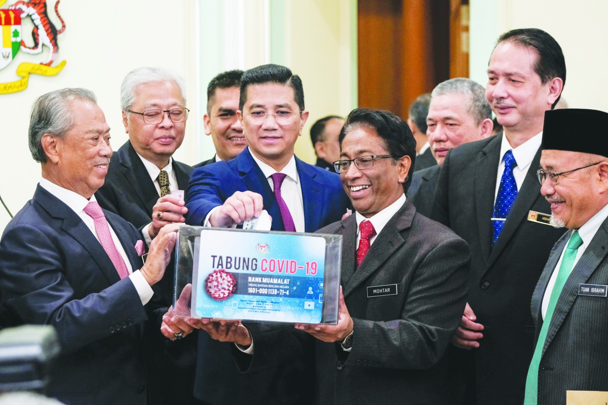 Malaysia's Prime Minister Tan Sri Muhyiddin Yassin (L) launched the COVID-19 relief fund after the first official Cabinet Meeting at the Prime Minister's Office in Putrajaya, Malaysia on March 11, 2020. (Syaiful Redzuan / Anadolu Agency)