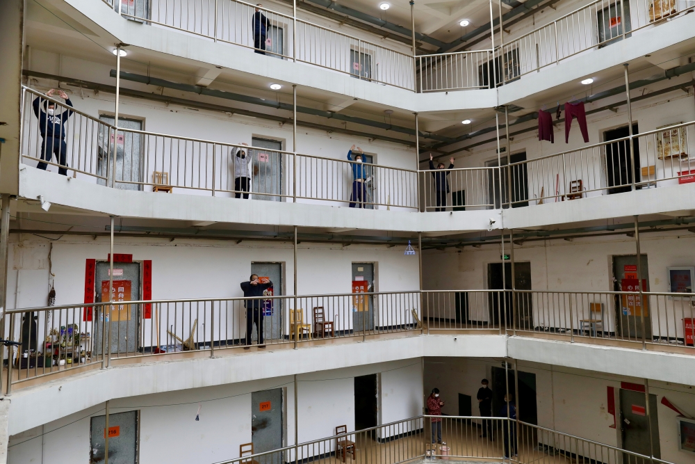  Patients who have been cured of the novel coronavirus disease (COVID-19) and discharged from hospitals exercise at a quarantine center in Wuhan, the epicentre of the novel coronavirus outbreak, in Hubei province, China March 12, 2020. China Daily via REU