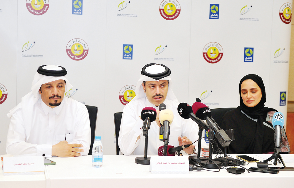 Nayef Abboud Al Shammari, Assistant Executive Director of Media at Hamad Medical Corporation;  Sheikh Dr. Mohammed bin Hamad Al Thani, Director of the Public Health Department at the MoPH, and Dr. Mona Al Muslimani, Medical Director at CDC, during a press
