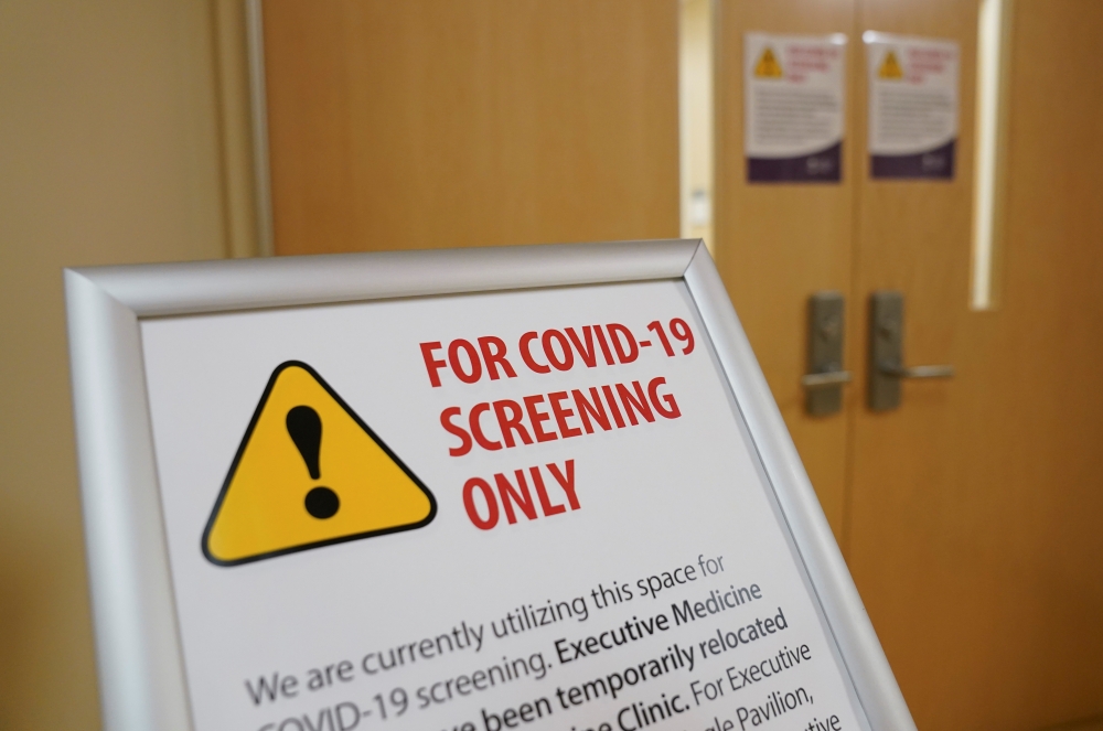A sign designates an area for coronavirus screening at Fort Belvoir Community Hospital in Fort Belvoir, Virginia, U.S., March 18, 2020. REUTERS/Kevin Lamarque