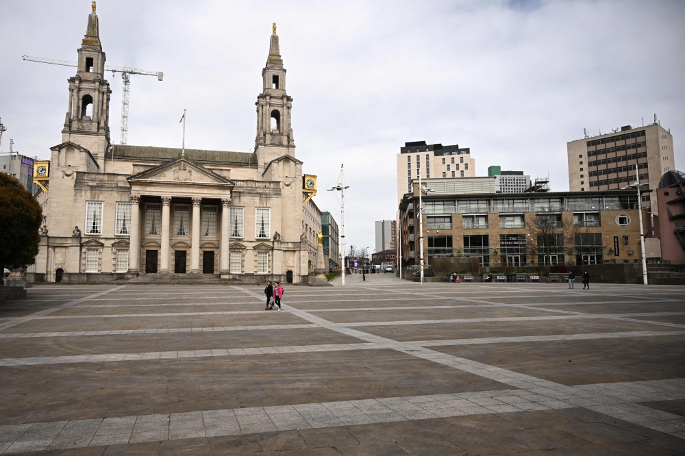 A virtually empty Millennium Square is seen in central Leeds on March 21, 2020, a day after the British government said it would help cover the wages of people hit by the coronavirus outbreak as it tightened restrictions to curb the spread of the disease.