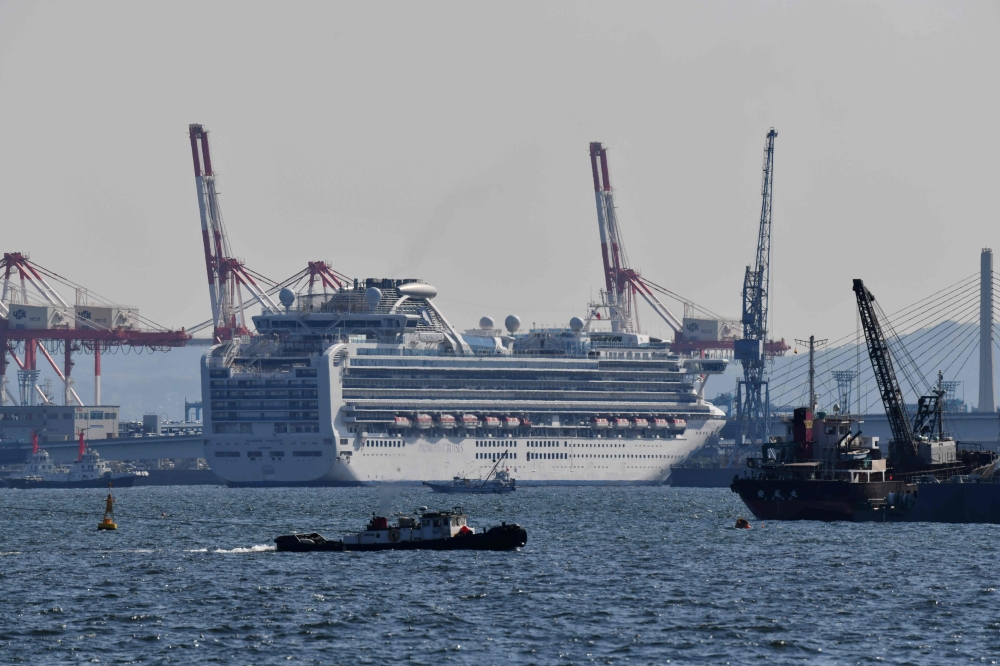 The Diamond Princess cruise ship is seen at a pier in the port of Yokohama on March 25, 2020. / AFP / Kazuhiro NOGI

