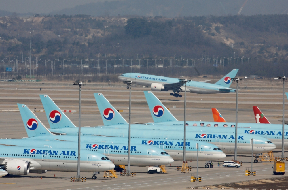 Korean Air's passenger planes are parked on the tarmac as overseas flight routes are reduced following the outbreak of coronavirus disease (COVID-19), at Incheon International Airport in Incheon, South Korea, March 24, 2020. REUTERS/Heo Ran/File Photo