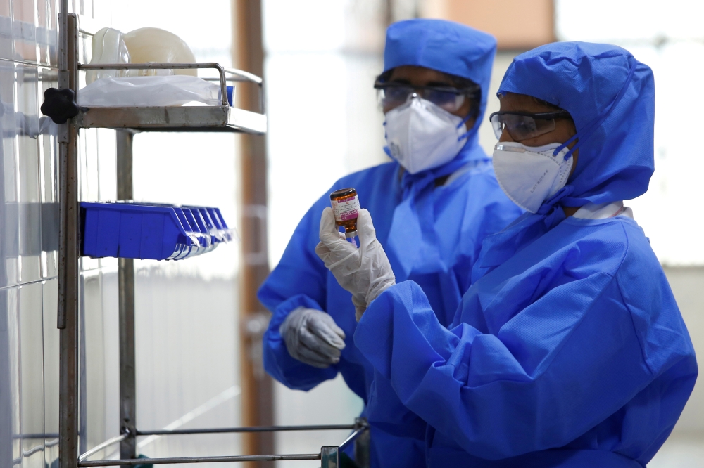 FILE PHOTO: Medical staff with protective clothing are seen inside a ward specialised in receiving any person who may have been infected with coronavirus, at the Rajiv Ghandhi Government General hospital in Chennai, India, January 29, 2020. REUTERS/P. Rav