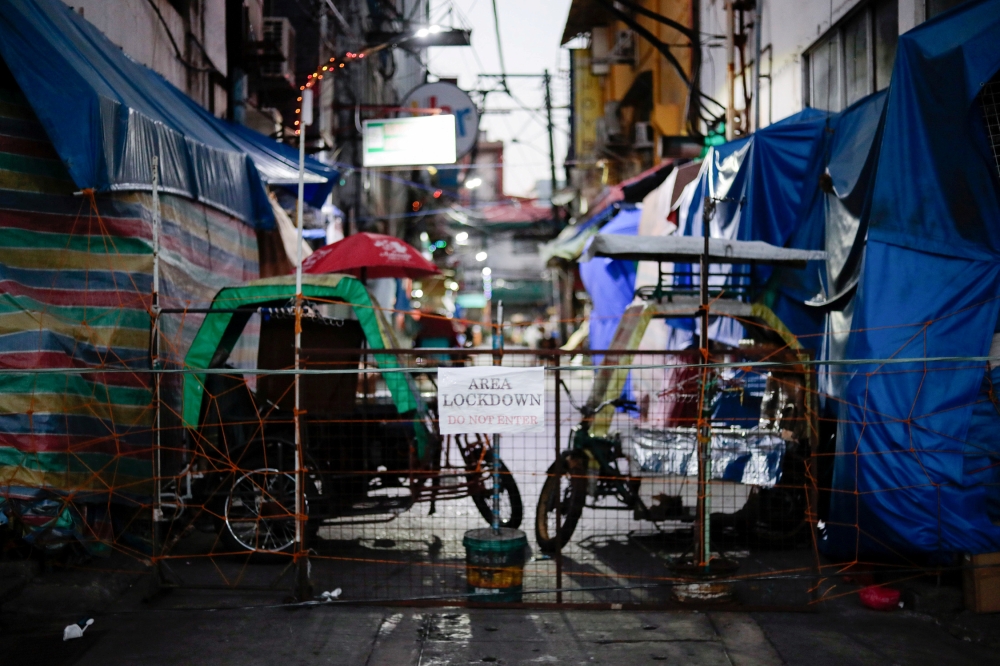 FILE PHOTO: Rickshaws block a street from outsiders to protect a neighborhood from the spread of the coronavirus disease (COVID-19) in Manila, Philippines, March 24, 2020. REUTERS/Eloisa Lopez/File Photo