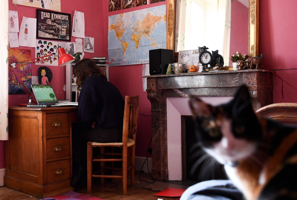 A high school student takes a test online at her home in Chisseaux near Tours on March 27, 2020, on the eleventh day of a lockdown in France to stop the spread of the novel coronavirus COVID-19. / AFP / Alain Jocard 