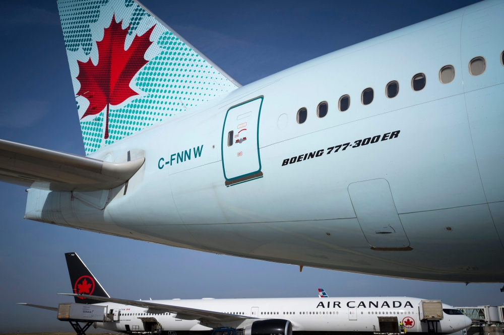  In this file photo taken on August 6, 2018 Air Canada planes sit on the tarmac of Roissy-Charles de Gaulle Airport, north of Paris. AFP / Joel Saget
 