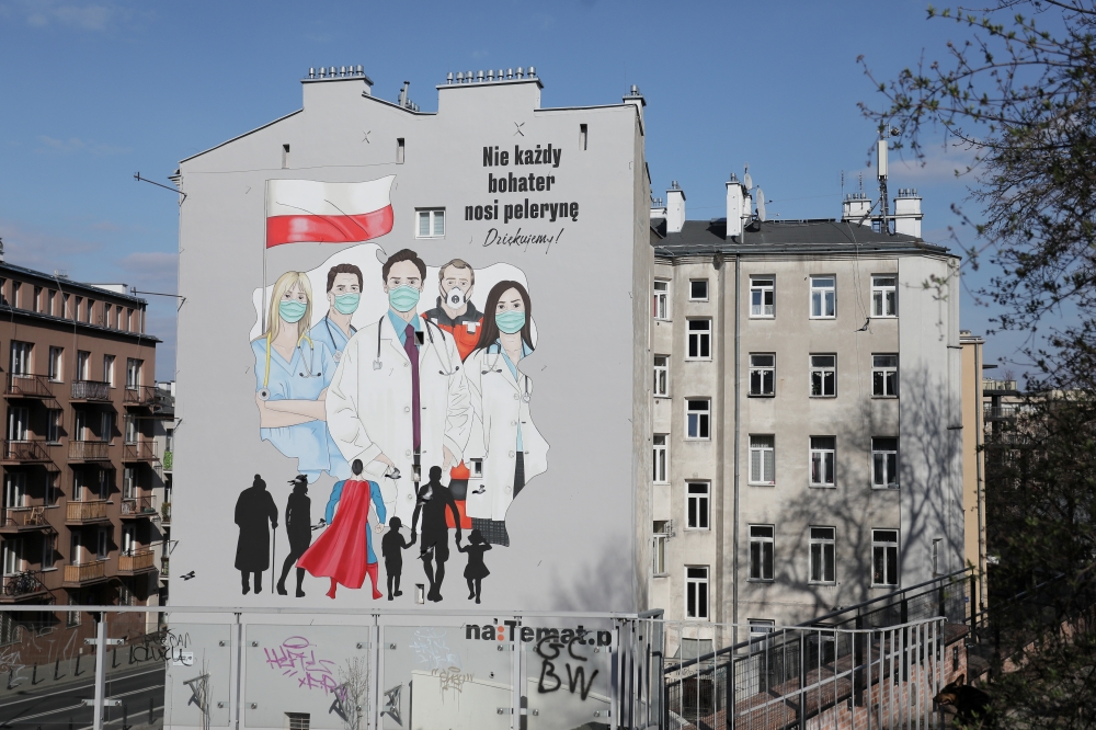 A mural showing medical personel wearing protective masks is painted on a wall of a building following the coronavirus disease (COVID-19) outbreak in Warsaw, Poland, April 1, 2020. Slawomir Kaminski/Agencja Gazeta via REUTERS