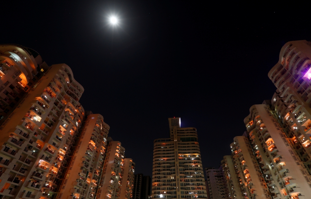  People stand on their balconies and light candles after Indian Prime Minister Narendra Modi appealed to Indians to turn out their lights for nine minutes at 9 p.m. to mark the coronavirus fight, during a lockdown to slow the spreading of coronavirus dise
