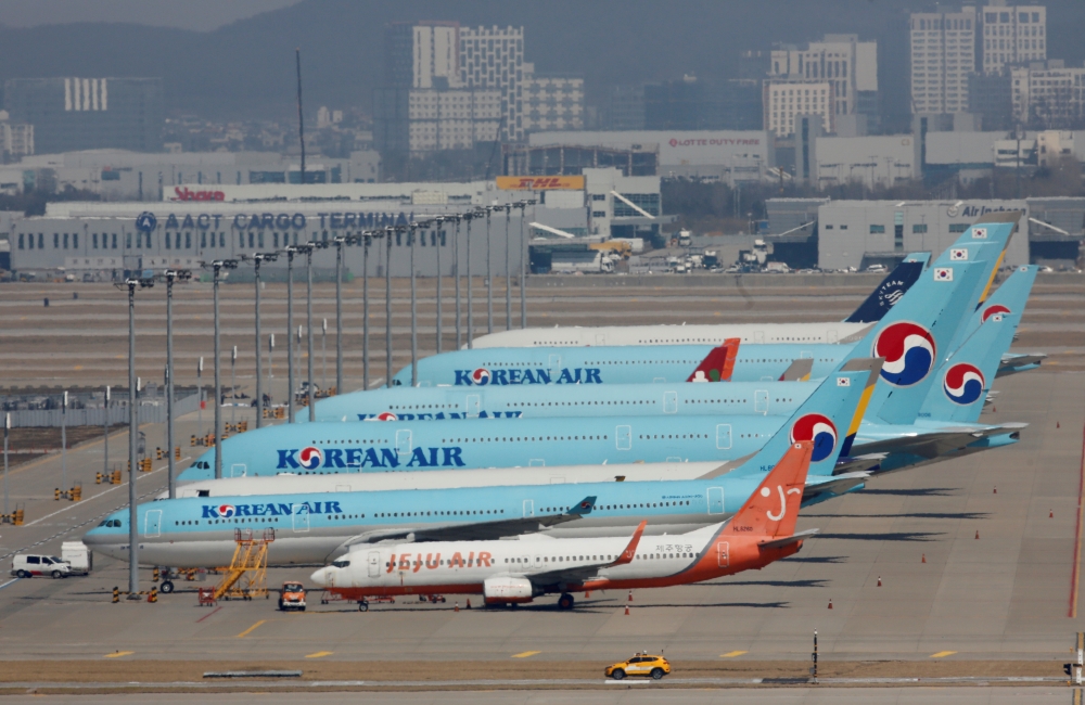 FILE PHOTO: Korean Air's passenger planes are parked at on the tarmac as overseas flight routes are reduced following the outbreak of coronavirus disease (COVID-19), at Incheon International Airport in Incheon, South Korea, March 24, 2020. REUTERS/Heo Ran