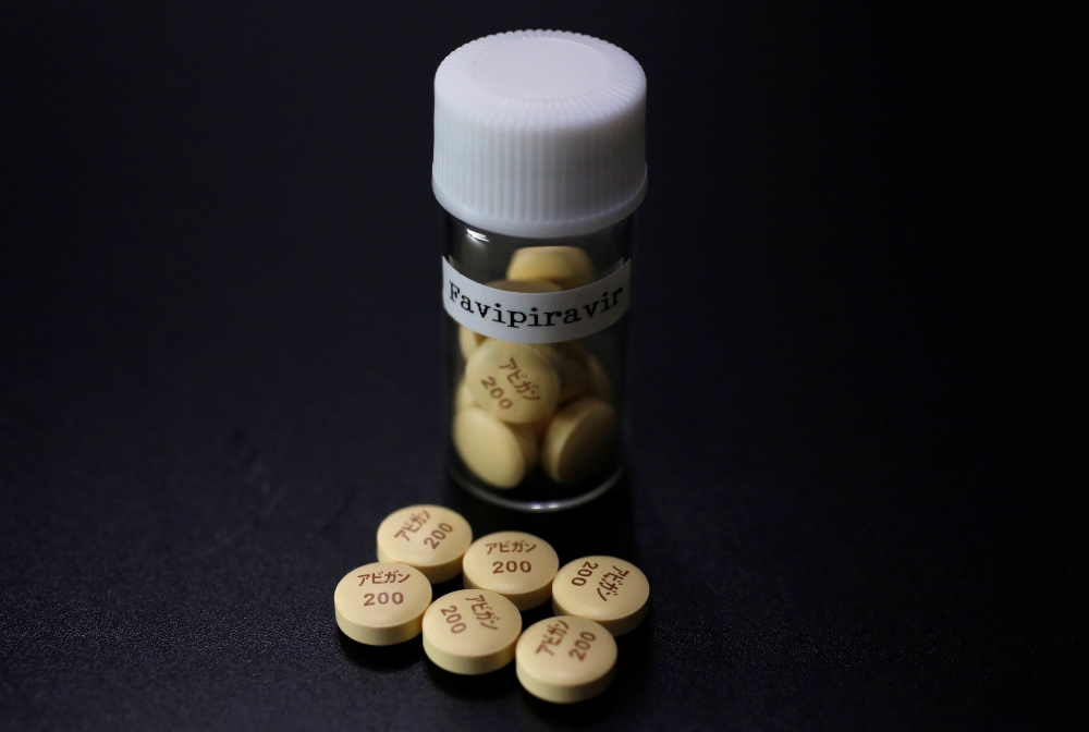 FILE PHOTO: Tablets of Avigan (generic name : favipiravir), a drug approved as an anti-influenza drug in Japan and developed by drug maker Toyama Chemical Co, a subsidiary of Fujifilm Holdings Co. are displayed during a photo opportunity at Fujifilm's hea