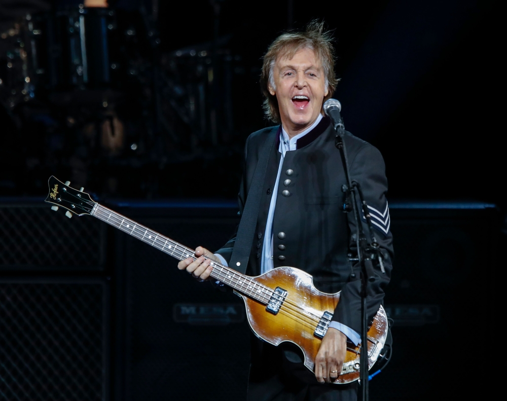 (FILES) In this file photo taken on July 26, 2017 Sir Paul McCartney performs in concert during his One on One tour at Hollywood Casino Amphitheatre in Tinley Park, Illinois. A sheet of paper bearing Paul McCartney's handwritten lyrics to 