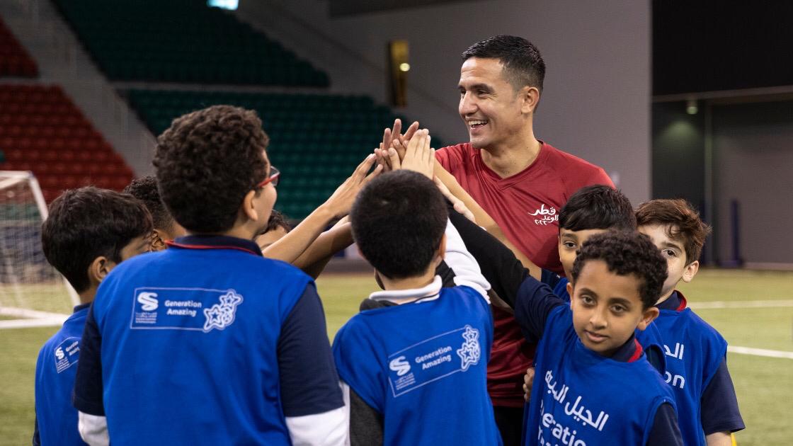 Australian legend and SC Global Ambassador Tim Cahill shares a light moment with young players during a training session in Doha as part of the Generation Amazing programme.