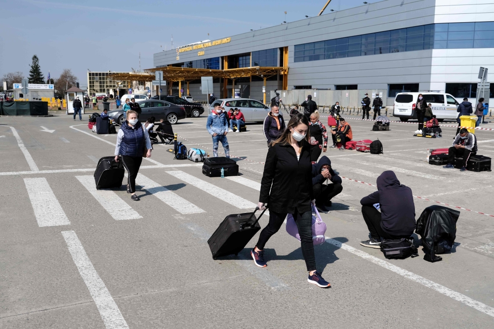 Romanians, hoping to travel to Germany, wait on the parking in front of 
