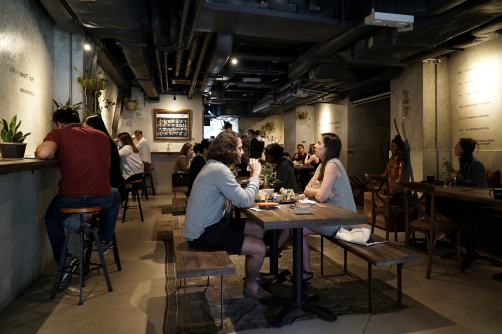 Customers eat at Mana Cafe in Wan Chai, Hong Kong, China April 14, 2020. Picture taken April 14, 2020. REUTERS/Pak Yiu