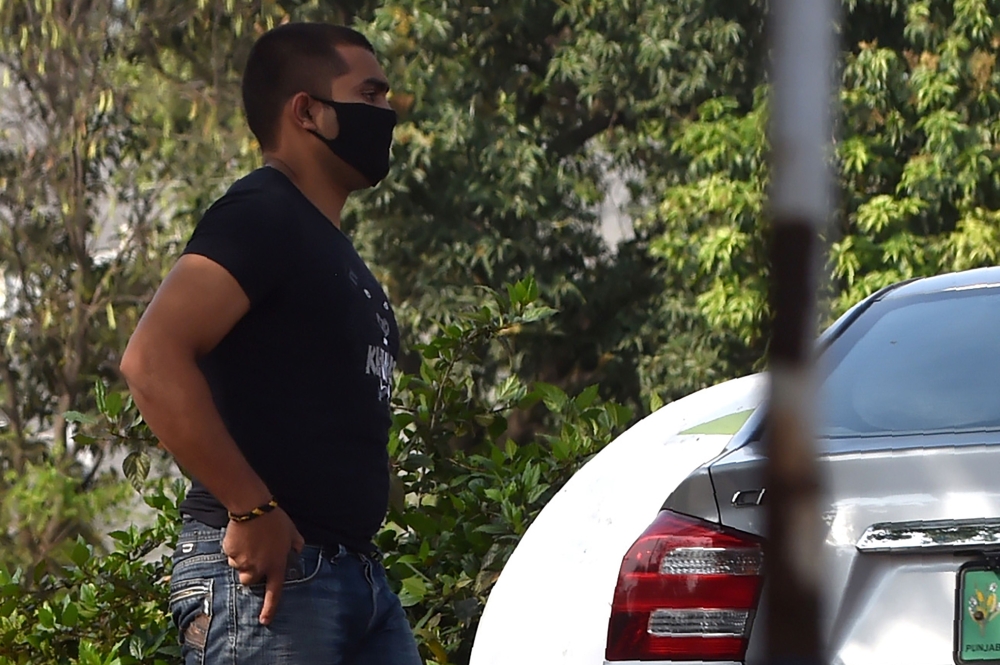 Pakistani cricketer Umar Akmal wearing a facemask leaves after appearing before a disciplinary committee in Lahore on April 27, 2020. AFP / Arif ALI