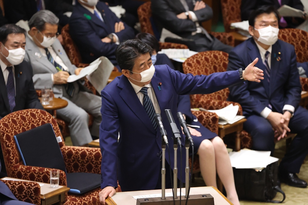 Japan's Prime Minister Shinzo Abe wearing a face mask speaks during a budget committee session at the parliament in Tokyo on 29 April 2020. Japan OUT / AFP / JIJI PRESS / STR