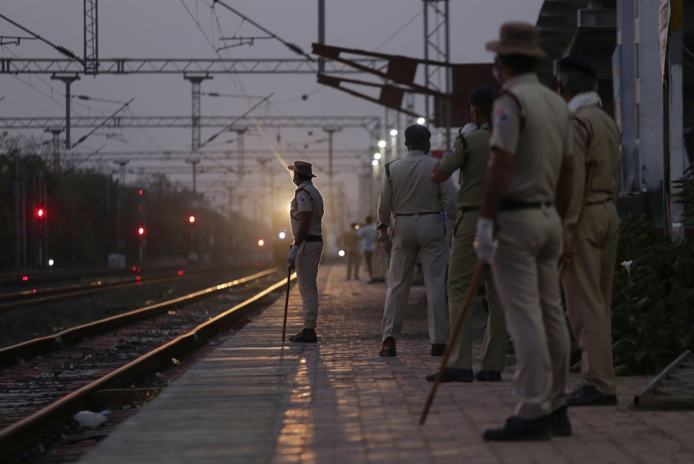 Railway Protection Force personnel stand at a platform as a special train carrying migrant labourers from Nasik arrives during a government-imposed nationwide lockdown as a preventive measure against the COVID-19 coronavirus, at Misrod railway station in 