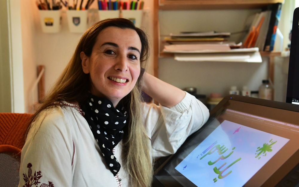 Artist Reem Ali Adeeb poses in her studio apartment in Los Angeles, California on April 29, 2020, where she is developing online tutorials in Arabic for children about art, including drawing and reading. AFP / Frederic J. Brown 