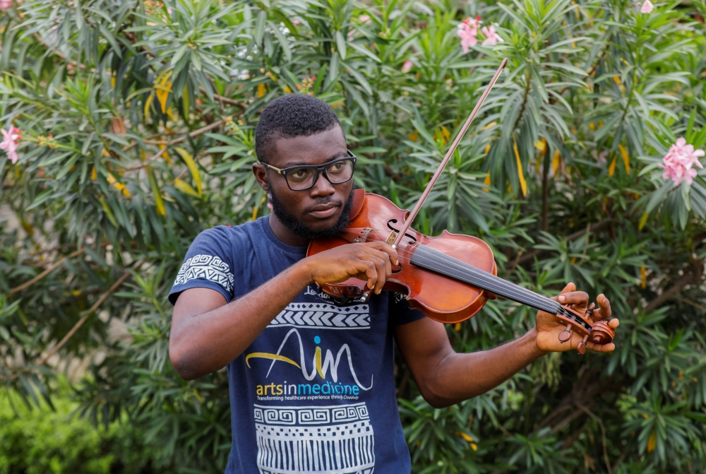 Nigerian Violinist, Peter Oluwadare, 23, who performs at weekly concerts at the isolation center, plays the violin during an interview with Reuters, amid the spread of coronavirus disease (COVID-19) in Lagos, Nigeria April 16, 2020. Picture taken April 16