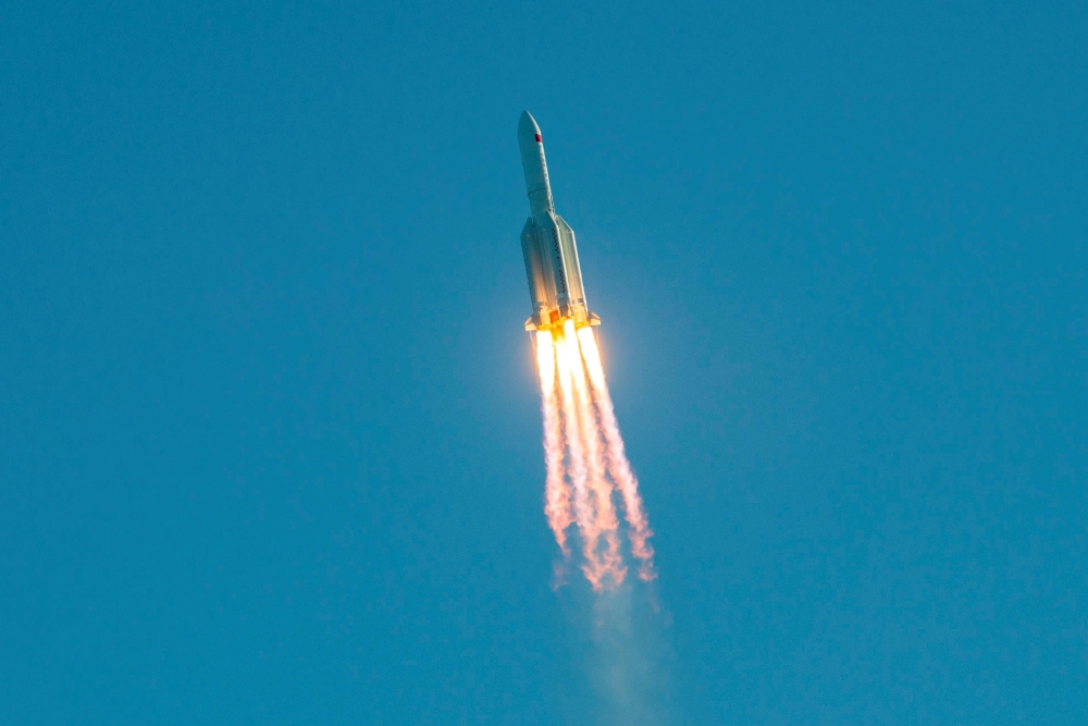 :(FILES) This file photo taken on May 5, 2020 shows a Long March 5B rocket lifting off from the Wenchang launch site on China's southern Hainan island. China's new prototype spacecraft 