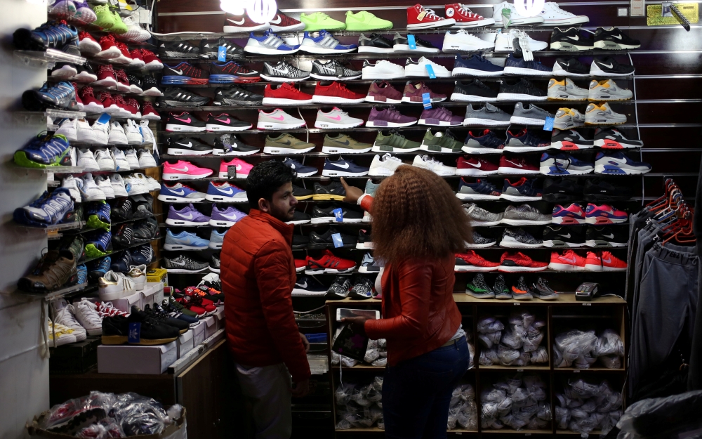 FILE PHOTO: A shopper points at items at a clothing store in Johannesburg, South Africa, June 9, 2017. Picture taken June 9, 2017. REUTERS/Siphiwe Sibeko/File Photo