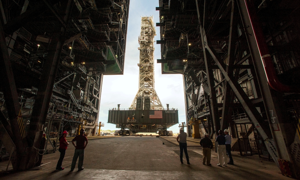 FILE PHOTO: NASA employees look on as the Artemis launch tower rolls back from Pad 39B inside Bay 3 of the Vehicle Assembly Building (VAB) at the Kennedy Space Center in preparation for the landfall of Hurricane Dorian, in Cape Canaveral, Florida, U.S., A