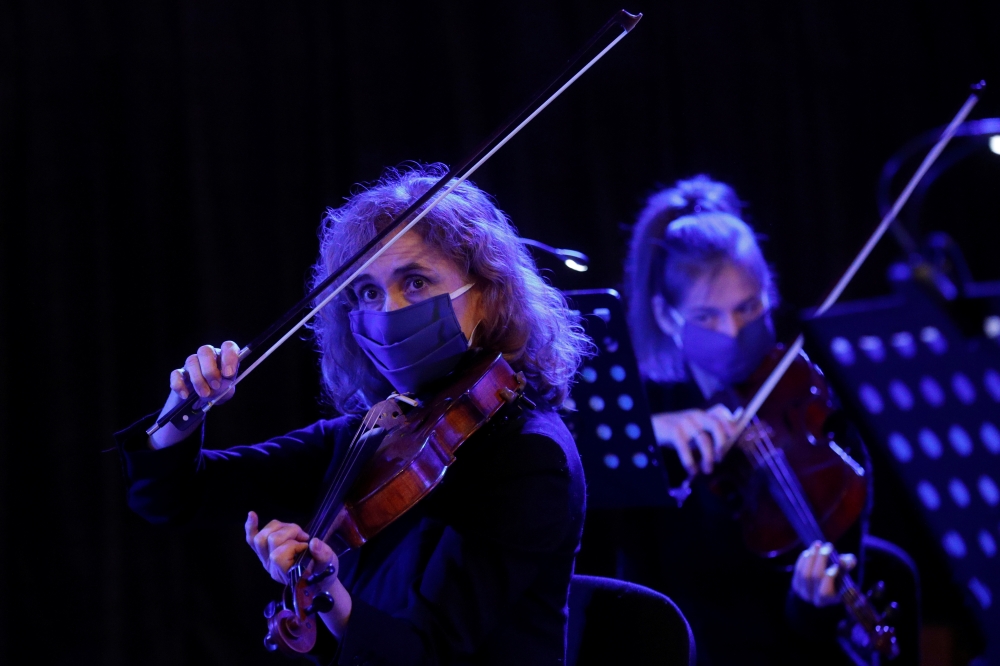 Musicians of the Ukrainian Radio Symphony Orchestra wear protective face masks as they take part in one of the first rehearsals after an easing of lockdown measures imposed to curb the spread of the coronavirus disease (COVID-19) in Kiev, Ukraine May 15, 