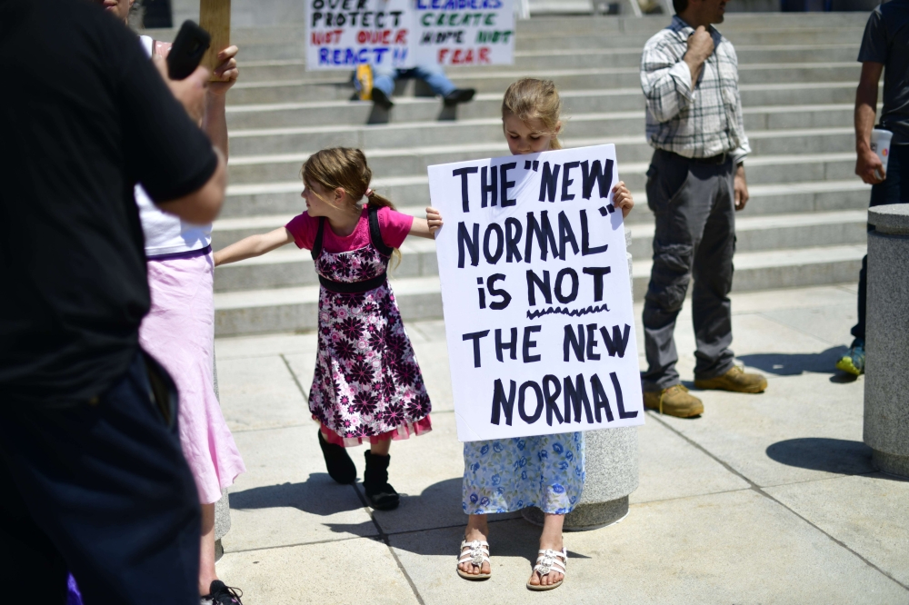 :HARRISBURG, PA - MAY 15: A girl holds a placard stating 