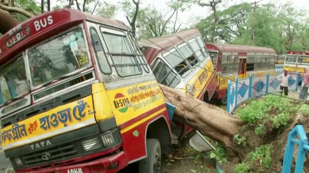 A bus damaged by a fallen tree due to Cyclone Amphan, is seen in Kolkata, West Bengal, India, May 21, 2020, in this still image from video. ANI via REUTERS

