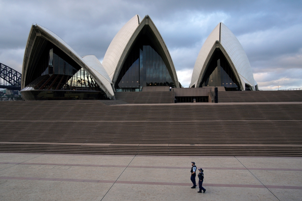 Police officers patrol near the Sydney Opera House following the implementation of stricter social-distancing and self-isolation rules to limit the spread of the coronavirus disease (COVID-19) in Sydney, Australia, April 6, 2020. REUTERS/Loren Elliott/Fil