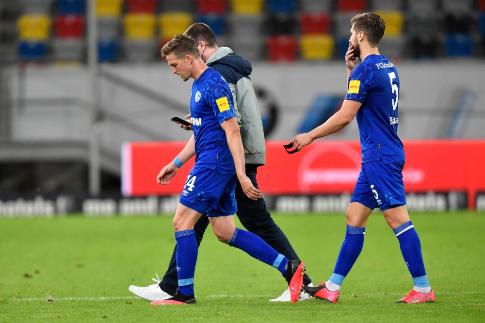 Schalke's German defender Bastian Oczipka (L) and Schalke's Serbian defender Matija Nastasic leave the pitch after the German first division Bundesliga football match Fortuna Duesseldorf v FC Schalke 04 on May 27, 2020 in Duesseldorf, western Germany. AFP