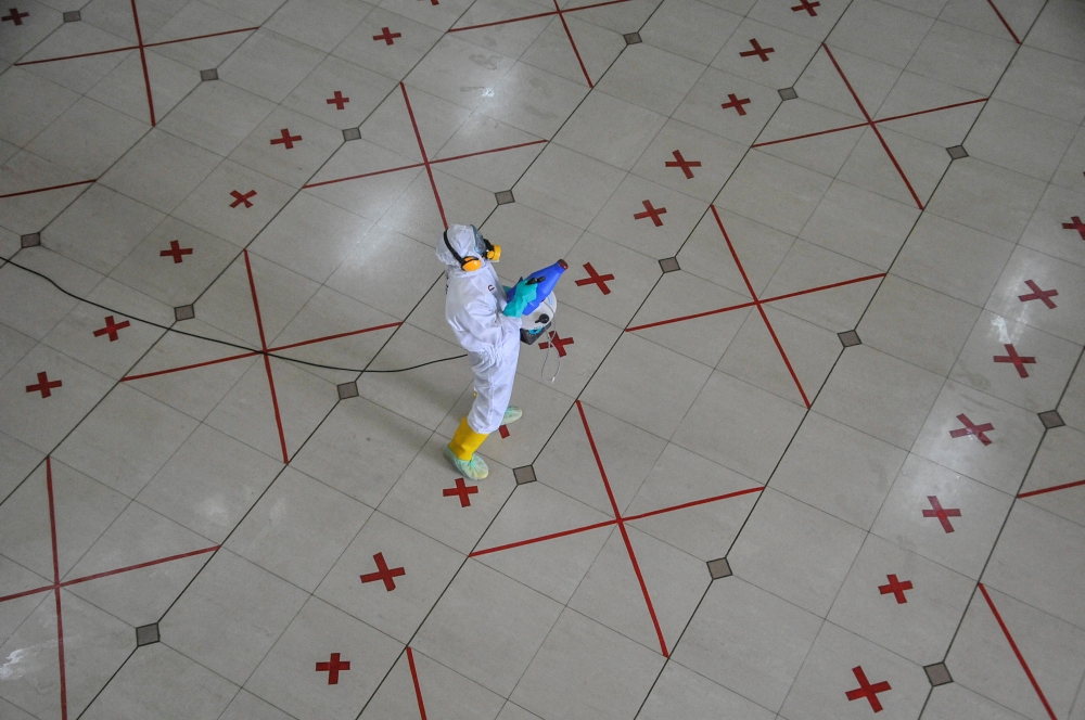A worker sprays disinfectant after Friday prayers at a mosque to prevent the spread of coronavirus disease (COVID-19) outbreak in Bekasi, near Jakarta, Indonesia May 29, 2020, in this photo taken by Antara Foto. Antara Foto/Fakhri Hermansyah