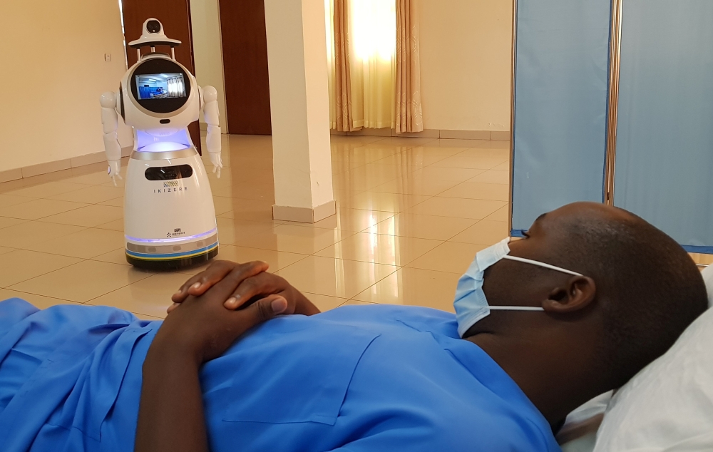 :A high-tech robot developed by Zora Bots, a Belgium-based company, and donated by the United Nations Development Program (UNDP) prepares to check the temperature of a health worker during a demonstration at the Kanyinya treatment centre that treats coron