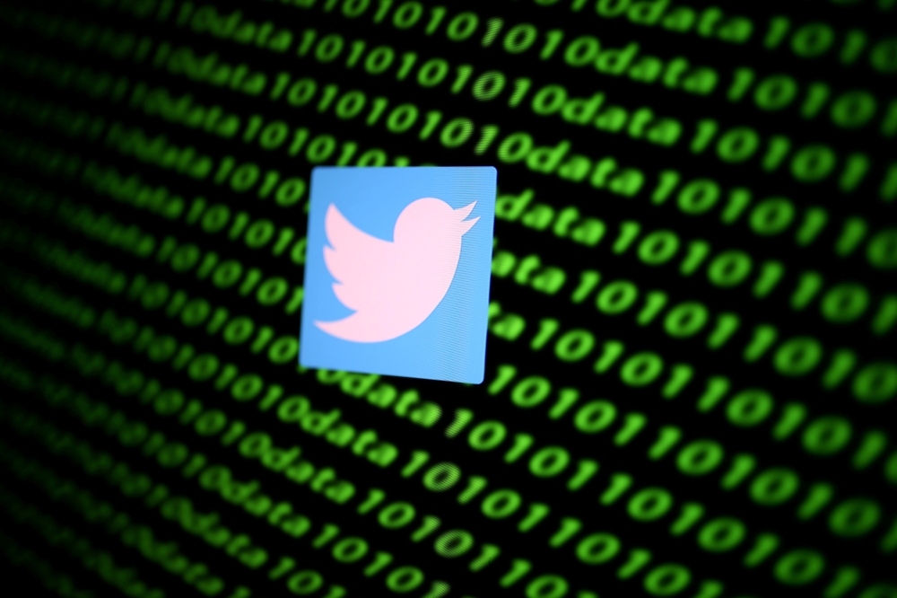 The Twitter logo and binary cyber codes are seen in this illustration taken November 26, 2019. REUTERS/Dado Ruvic/Illustration/File Photo