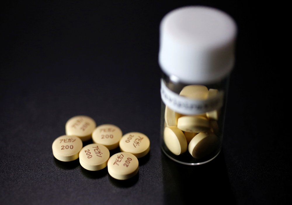 FILE PHOTO: Tablets of Avigan (generic name : Favipiravir), a drug approved as an anti-influenza drug in Japan and developed by drug maker Toyama Chemical Co, a subsidiary of Fujifilm Holdings Co. are displayed during a photo opportunity at Fujifilm's hea