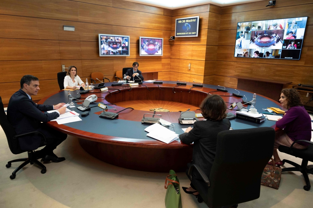 Spanish Prime Minister Pedro Sanchez (L) holding a cabinet meeting at La Moncloa Palace in Madrid on May 26, 2020. 