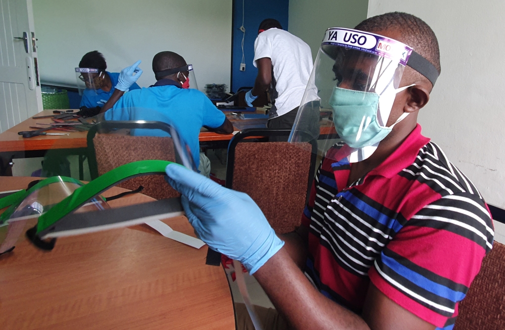 Workers prepare face shields from recycled plastics at the Zaidi Recyclers workshop as a measure to stop the spread of coronavirus disease (COVID-19) in Dar es Salaam, Tanzania May 27, 2020. Picture taken May 27, 2020. REUTERS/Stringer